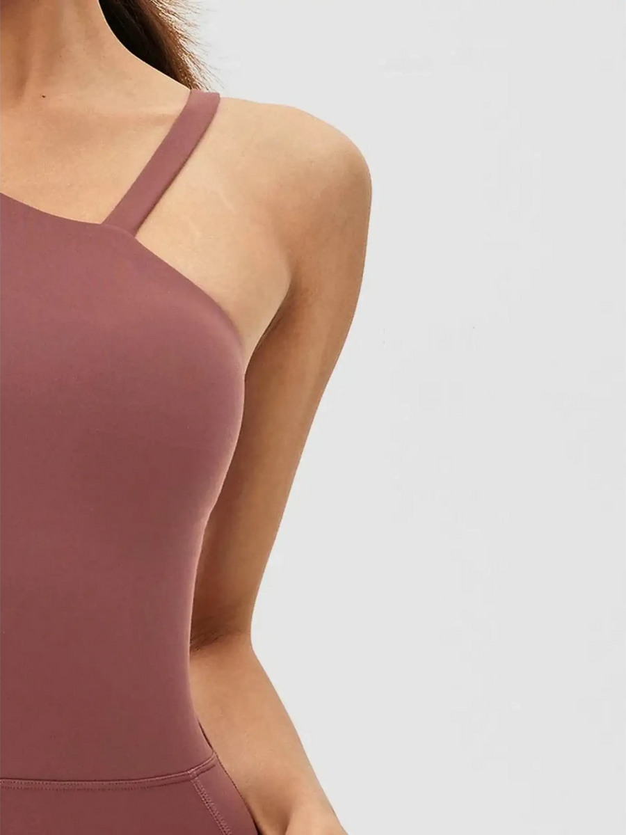 Close-up of Babe Beachwear asymmetrical neck activewear jumpsuit for women in mauve color