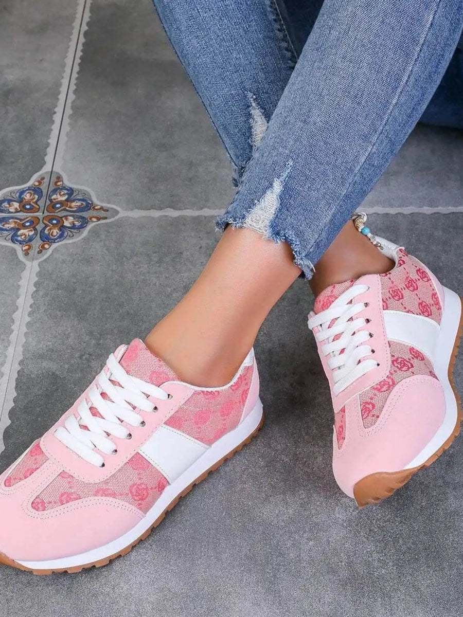 Trendsi affordable summer flat sneakers in pink with white accents worn with ripped blue jeans