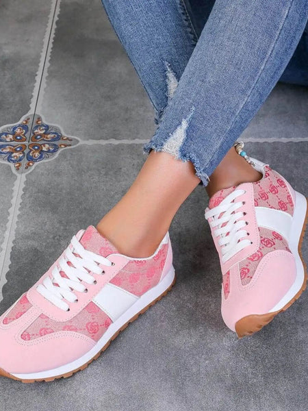 Trendsi affordable summer flat sneakers in pink with white accents worn with ripped blue jeans