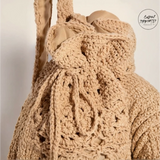 Beige crochet knit shoulder bag with intricate braided drawstring for boho beach vibes