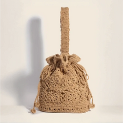 Crochet knit shoulder bag with intricate braided drawstring and handle for boho style