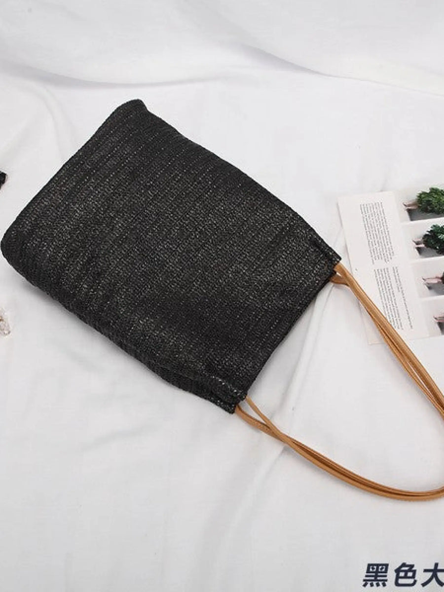 Black woven tote bag with brown handles perfect for stylish straw totes and beach days