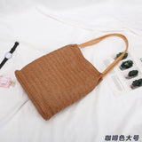 Brown woven straw tote with leather straps perfect for stylish beach days and straw totes
