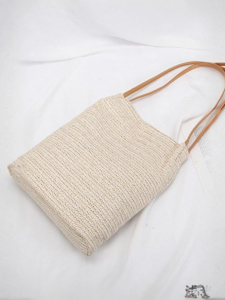 Stylish straw tote with brown straps, perfect for beach days and summer adventures