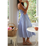 Trendsi blue and white striped beach midi dress with spaghetti straps worn indoors