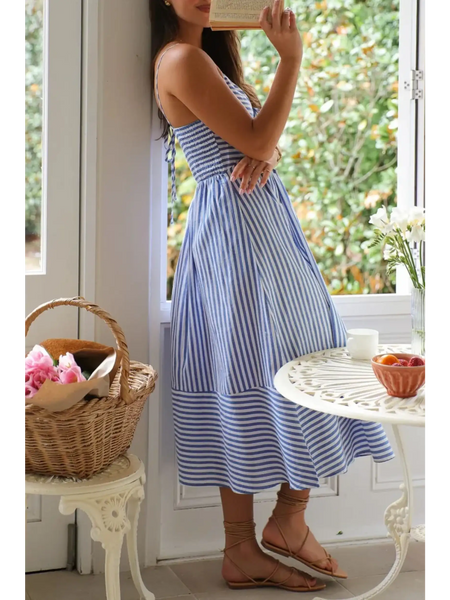 Trendsi blue and white striped beach midi dress with spaghetti straps worn indoors