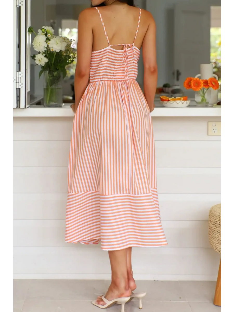 Trendsi striped beach midi dress with spaghetti straps and back tie detail on woman indoors