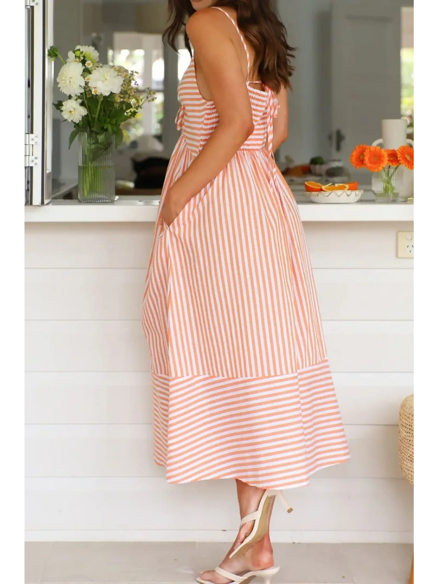 Trendsi striped beach midi dress with pockets and adjustable straps worn by woman indoors