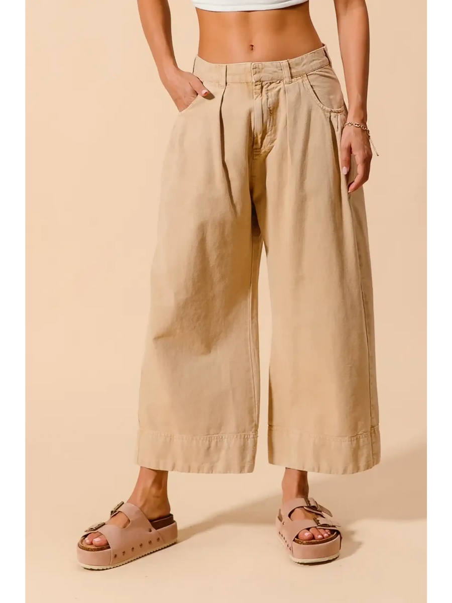 Beige chic wide leg trousers for women by Babe Beachwear styled with platform sandals