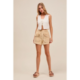 Trendsi High Rise Cargo Shorts in beige with large front pockets worn by model with white sleeveless top