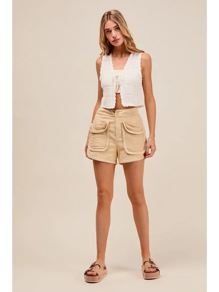 Trendsi High Rise Cargo Shorts in beige with large front pockets worn by model with white sleeveless top