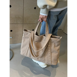 Babe Beachwear lightweight Ladies duffle bag in beige corduroy fabric held by a person wearing casual clothes
