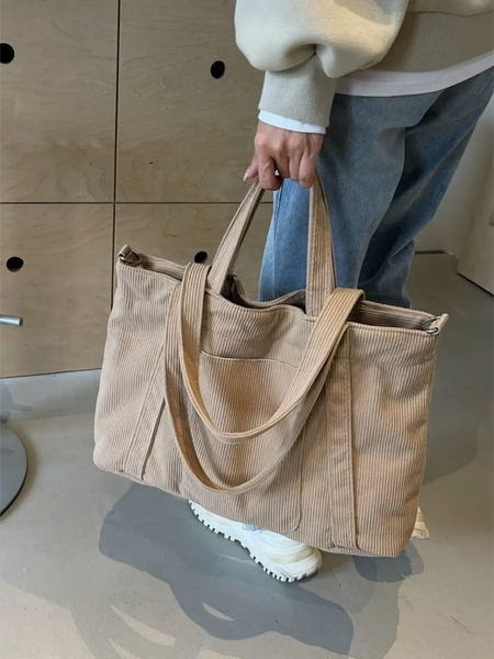 Babe Beachwear lightweight Ladies duffle bag in beige corduroy fabric held by a person wearing casual clothes