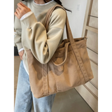 Lightweight Ladies duffle bag in beige corduroy fabric carried over shoulder by woman