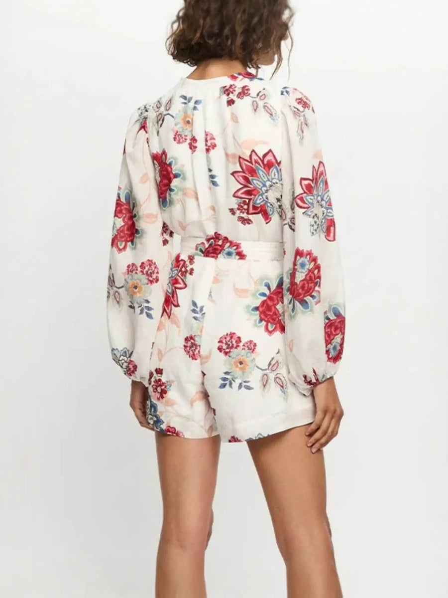 Babe Beachwear belted floral summer romper with long sleeves and colorful flower print back side view