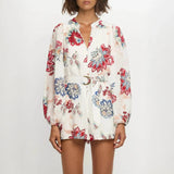 Babe Beachwear belted floral summer romper with long sleeves and colorful flower print
