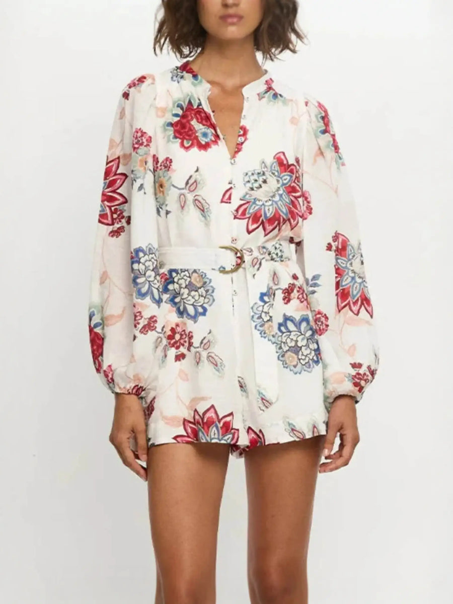 Babe Beachwear belted floral summer romper with long sleeves and vibrant red and blue flower print