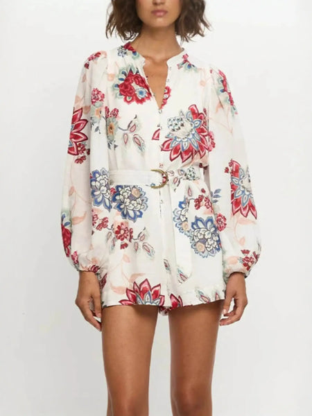 Babe Beachwear belted floral summer romper with long sleeves and vibrant red and blue flower print