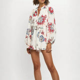 Babe Beachwear belted floral summer romper with long sleeves and vibrant flower prints