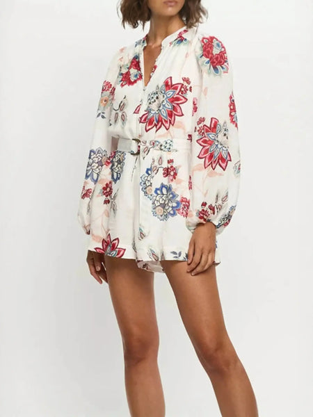 Babe Beachwear belted floral summer romper with long sleeves and vibrant flower prints