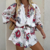 Babe Beachwaer belted floral summer romper with long sleeves and red blue flower print