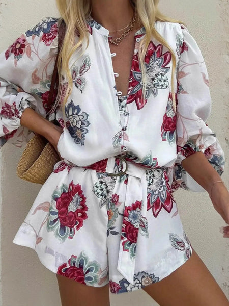 Babe Beachwaer belted floral summer romper with long sleeves and red blue flower print