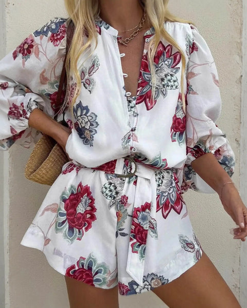 Babe Beachwaer belted floral summer romper with long sleeves and red blue flower print