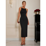 Woman wearing a black bodycon dress for women by Babe Beachwaer holding a glass of wine indoors