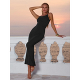 Babe Beachwear black bodycon dress for women modeled at sunset by sea with sleeveless design