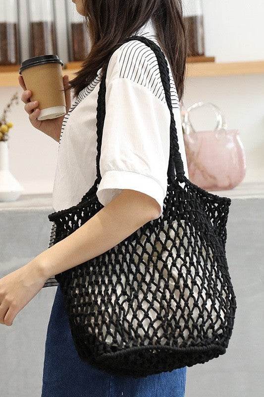 Miss Sparkling black braided net beach tote carried by woman with coffee cup in hand