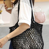 Miss Sparkling black braided net beach tote carried by woman with coffee cup in hand