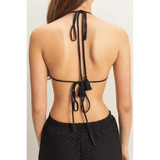 Back view of woman wearing black crochet bikini cover up pants set from Trendsi with tie details