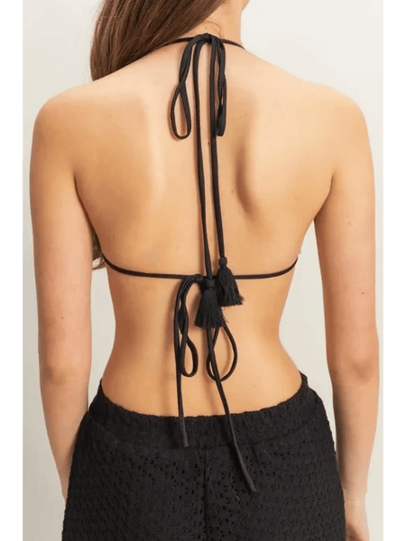Back view of woman wearing black crochet bikini cover up pants set from Trendsi with tie details