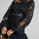 Babe Beachwear black lace mini dress with long sleeves and intricate cutout details