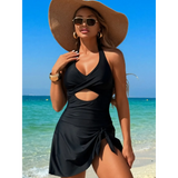 Beach Babes sexy cutout swim dress in black worn by woman with wide-brim hat on ocean beach