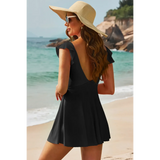 Beach Babes Swimdress Swimsuit with Coverage and Flowy Skirt in black worn by woman on beach