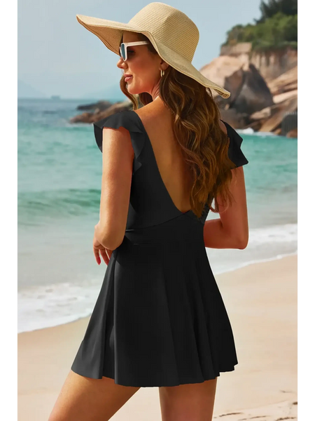 Beach Babes Swimdress Swimsuit with Coverage and Flowy Skirt in black worn by woman on beach