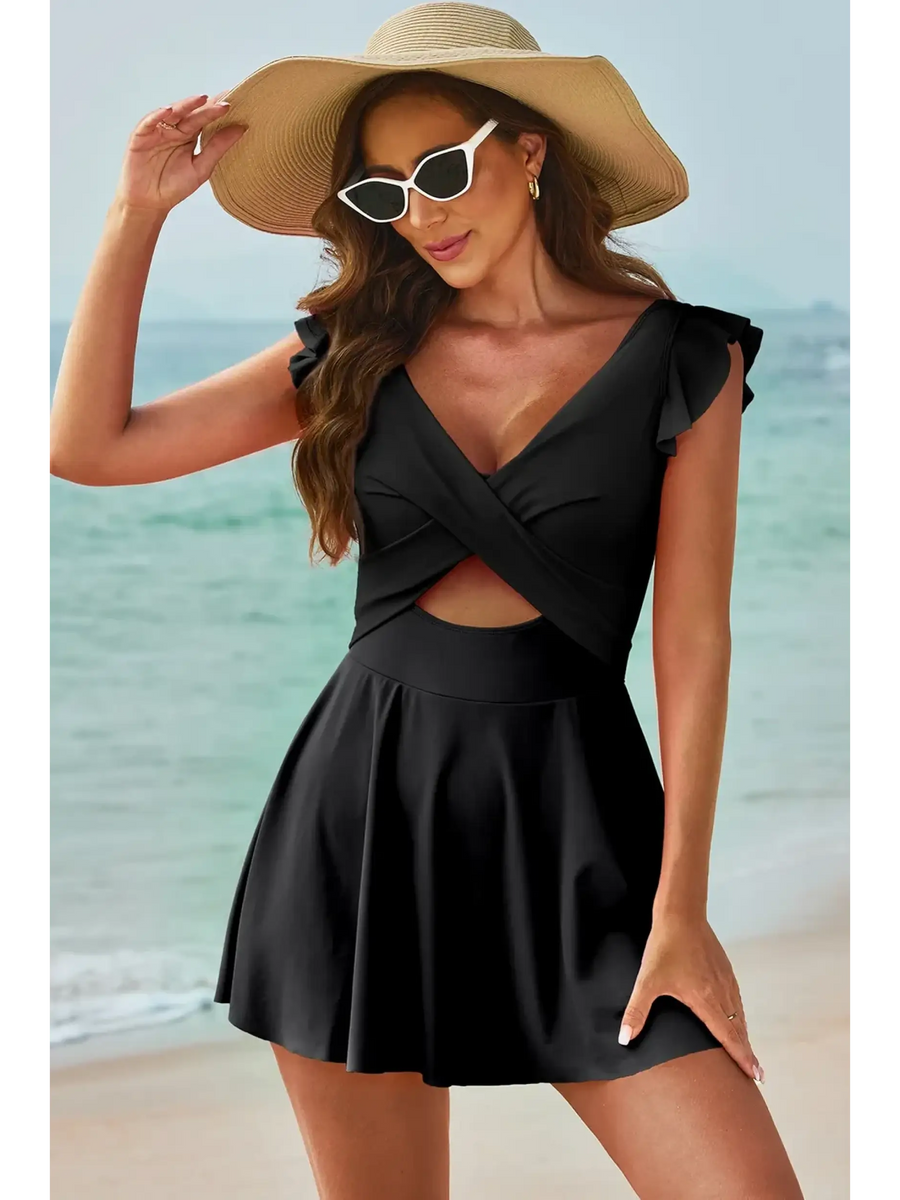 Beach Babes swimdress swimsuit with coverage and flowy skirt in black worn by woman at the beach