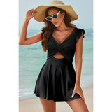 Beach Babes swimdress swimsuit with coverage and flowy skirt in black worn by woman at the beach