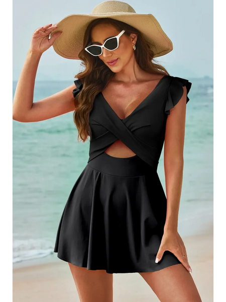 Beach Babes swimdress swimsuit with coverage and flowy skirt in black worn by woman at the beach