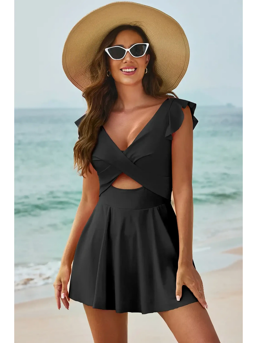 Beach Babes Swimdress Swimsuit with Coverage and Flowy Skirt in black worn by woman on beach with hat and sunglasses