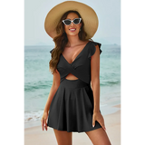 Beach Babes Swimdress Swimsuit with Coverage and Flowy Skirt in black worn by woman on beach with hat and sunglasses