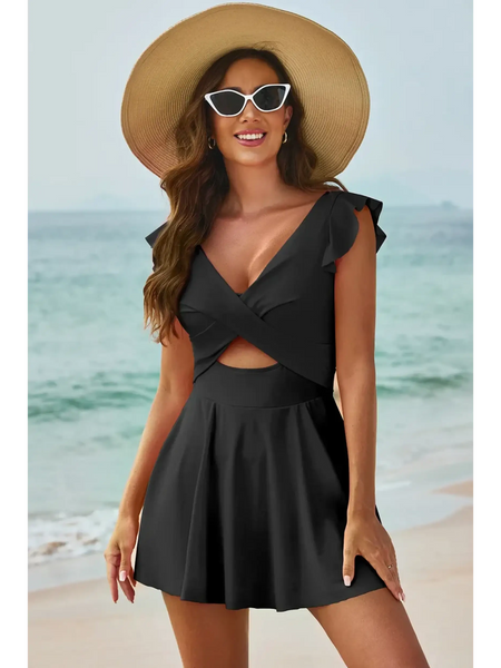 Beach Babes Swimdress Swimsuit with Coverage and Flowy Skirt in black worn by woman on beach with hat and sunglasses