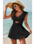 Beach Babes swimdress swimsuit with coverage and flowy skirt in black worn by woman on the beach