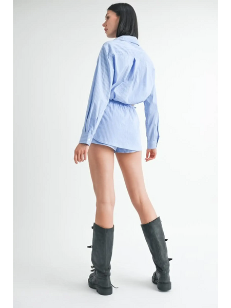 Woman wearing Emory Park blue and white cotton beach top paired with black knee-high boots