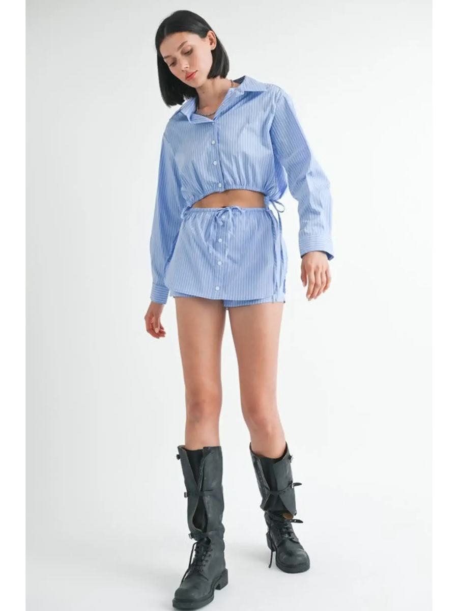 Woman wearing Emory Park blue and white cotton beach top with matching shorts and black boots