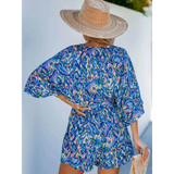 Babe Beachwear blue batwing romper for travel with vibrant pattern and loose fit shown from the back
