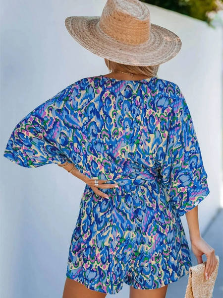 Babe Beachwear blue batwing romper for travel with vibrant pattern and loose fit shown from the back
