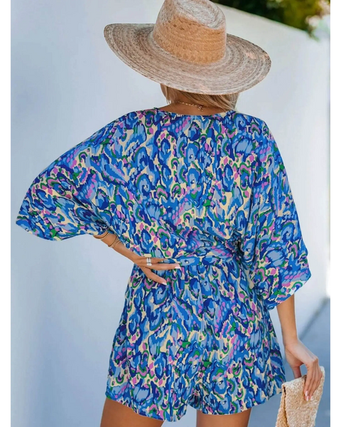 Babe Beachwear blue batwing romper for travel with vibrant pattern and loose fit shown from the back