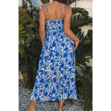 woman wearing blue floral maxi dress with a back view with spaghetti straps and fitted waist midi dress
